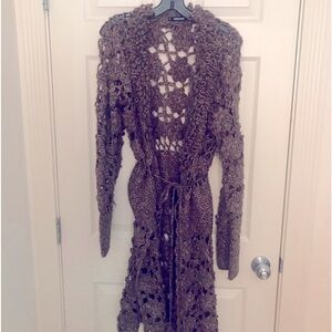 Multi colored, mid length, vented sweater by Mistress.